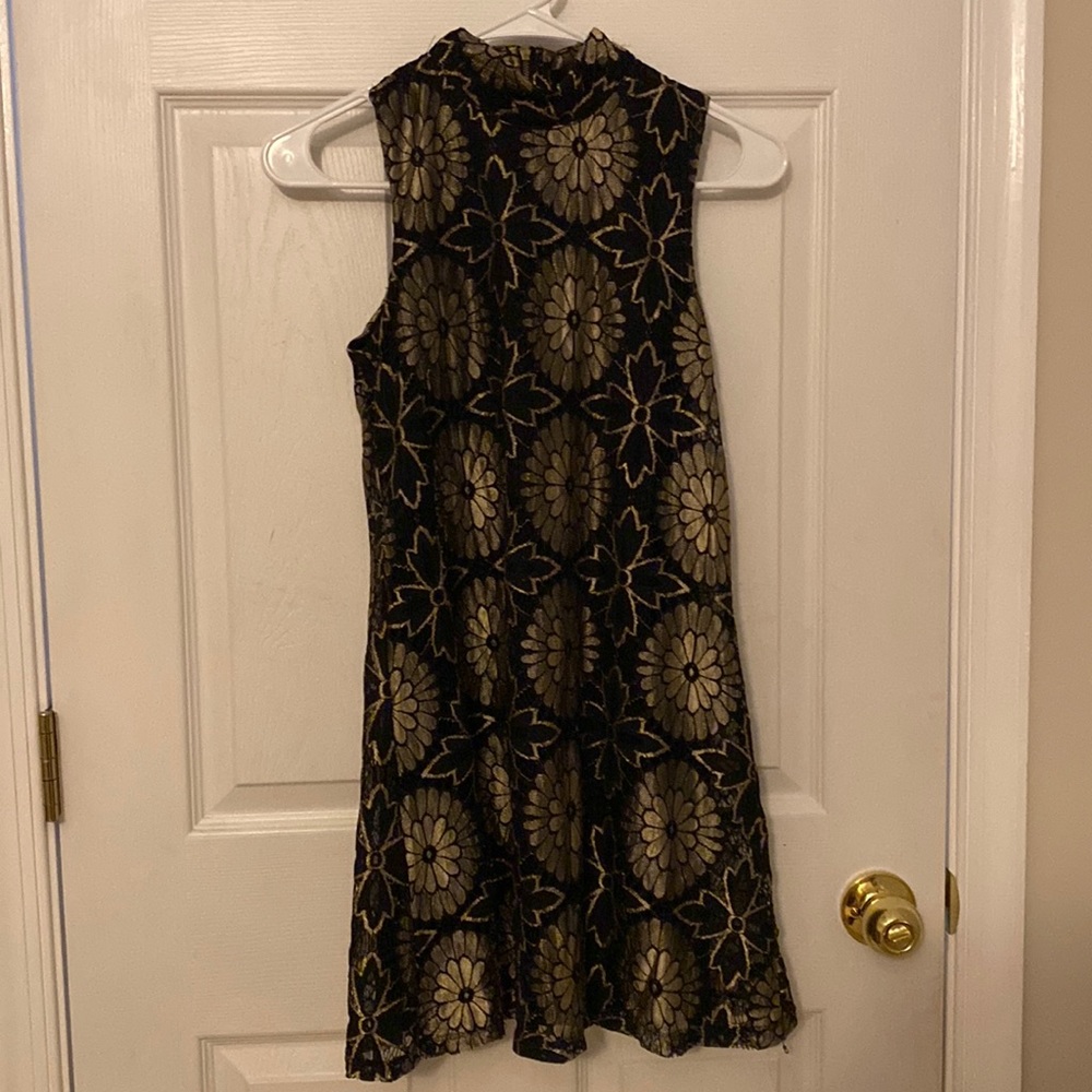 Black dress with gold floral patterns.